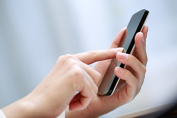 Image showing Close up of a woman using smartphone