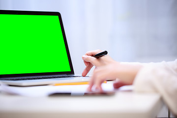 Image showing Woman analyzing something at laptop.