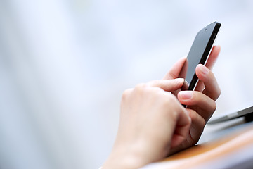 Image showing Close up of a woman using smartphone