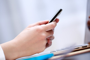 Image showing Close up of a woman using smartphone