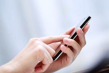 Image showing Close up of a woman using smartphone