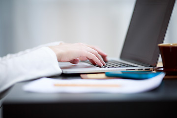 Image showing Close-up shot typing on the laptop keyboard