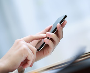 Image showing Close up of a woman using smartphone