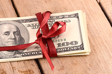 Image showing Bundle of dollars tied with ribbon