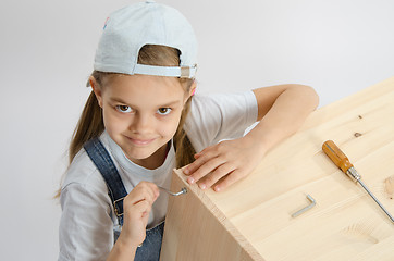 Image showing Little girl in dress collector furniture screw screwed Allen