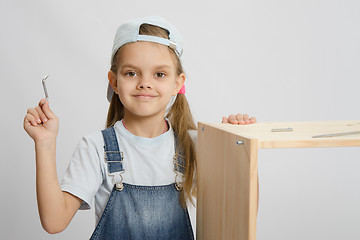 Image showing Little girl in image collector of furniture with tools