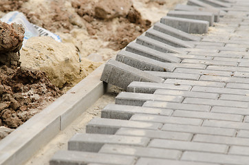 Image showing Laying of paving slabs to curb