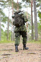 Image showing young soldier with backpack in forest