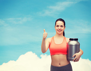 Image showing teenage girl with jar of protein showing thumbs up