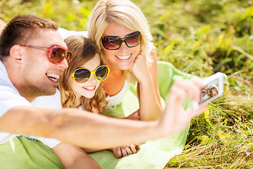 Image showing happy family with camera taking picture