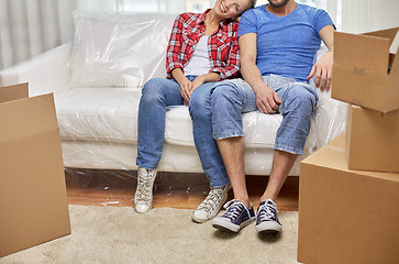 Image showing close up of couple relaxing on sofa in new home