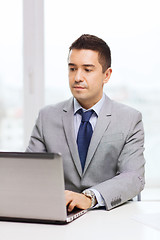 Image showing businessman working with laptop in office