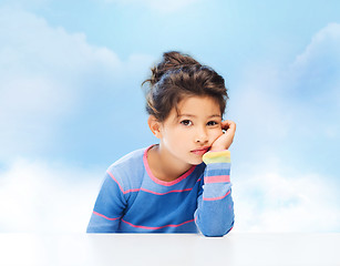 Image showing sad little girl over city background