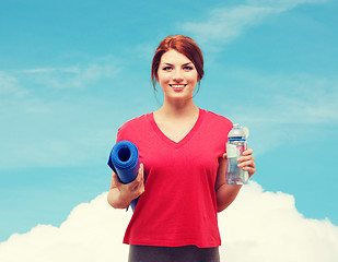 Image showing smiling girl with bottle of water after exercising