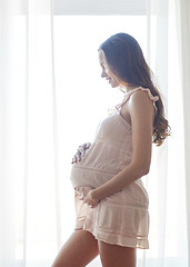 Image showing happy pregnant woman with big bare tummy at home