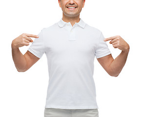 Image showing smiling man in t-shirt pointing fingers on himself