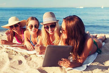 Image showing group of smiling young women with tablets on beach