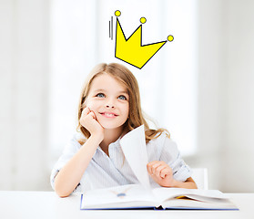 Image showing smiling girl reading fairytales at home