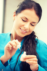 Image showing beautiful woman polishing her nails