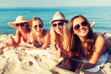 Image showing group of smiling young women with tablets on beach