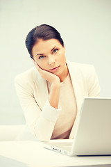 Image showing pensive woman with laptop computer