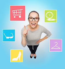 Image showing smiling asian woman in eyeglasses with finger up