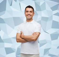 Image showing smiling man in white t-shirt with crossed arms