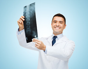 Image showing smiling male doctor in white coat holding x-ray