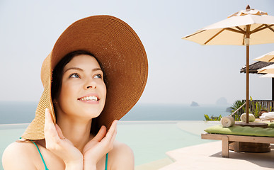 Image showing happy young woman in straw hat on tropical beach