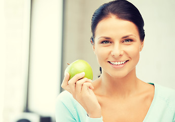 Image showing lovely housewife with green apple