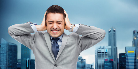 Image showing businessman in suit having head ache