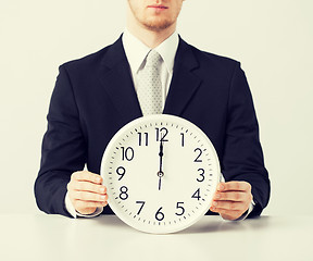 Image showing man with wall clock