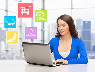 Image showing smiling businesswoman or student with laptop