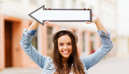 Image showing girl showing direction with arrow in the city