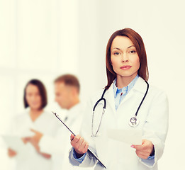 Image showing calm female doctor with clipboard