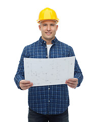 Image showing smiling male builder in helmet with blueprint