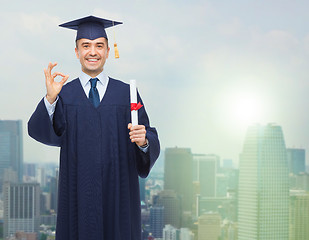 Image showing smiling adult student in mortarboard with diploma