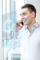 Image showing smiling businessman with smartphone in office