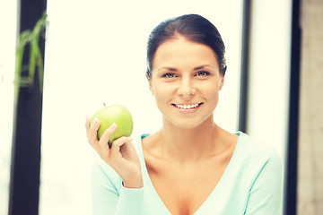 Image showing lovely housewife with green apple