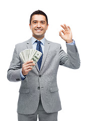 Image showing smiling businessman with american dollar money