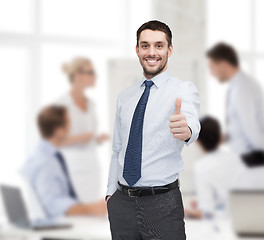 Image showing handsome businessman showing thumbs up