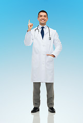 Image showing happy male doctor in white coat pointing finger up