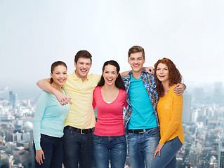 Image showing group of smiling teenagers over city background