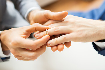 Image showing close up of male gay couple hands and wedding ring