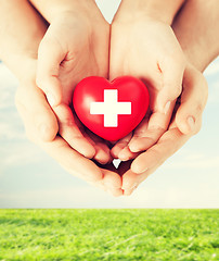 Image showing male and female hands with red heart