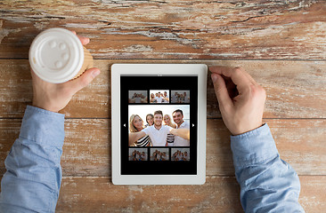 Image showing close up of male hands with photo on tablet pc