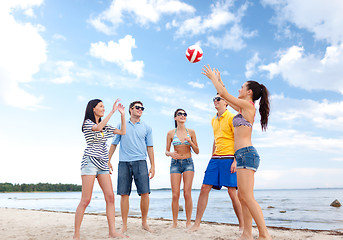 Image showing group of happy friends playing beach ball