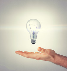 Image showing man hand with light bulb