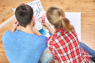 Image showing close up of couple with blueprint and palettes