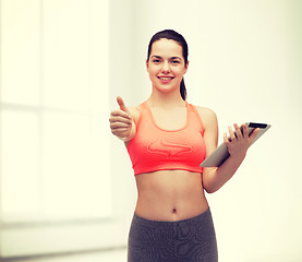 Image showing sporty woman with tablet pc computer